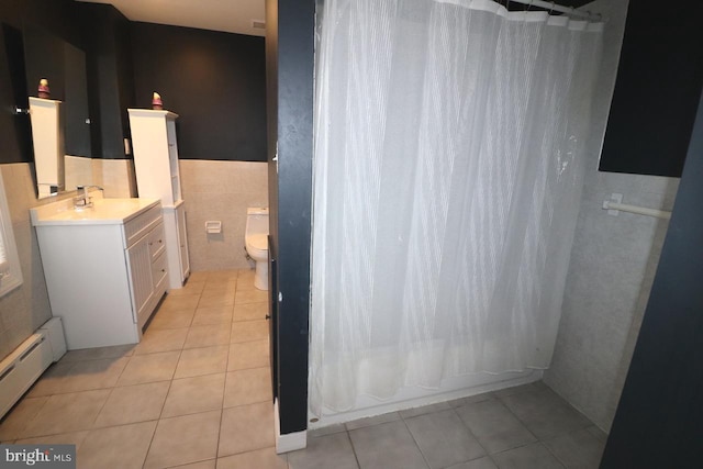 full bathroom featuring tile walls, tile patterned floors, baseboard heating, and toilet