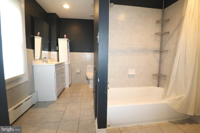 full bathroom with tile walls, tile patterned flooring, a baseboard heating unit, toilet, and shower / bath combo with shower curtain