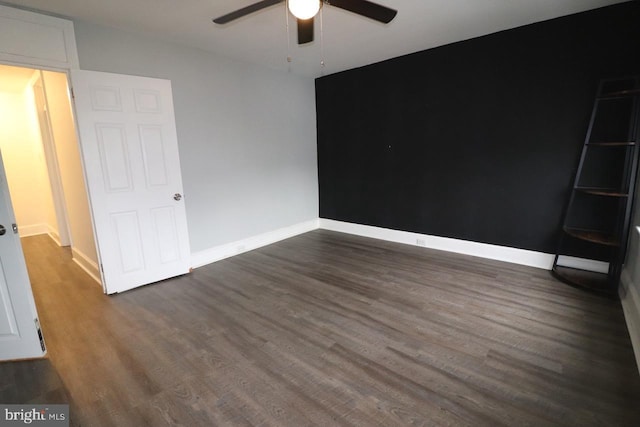 unfurnished bedroom featuring ceiling fan and dark hardwood / wood-style flooring