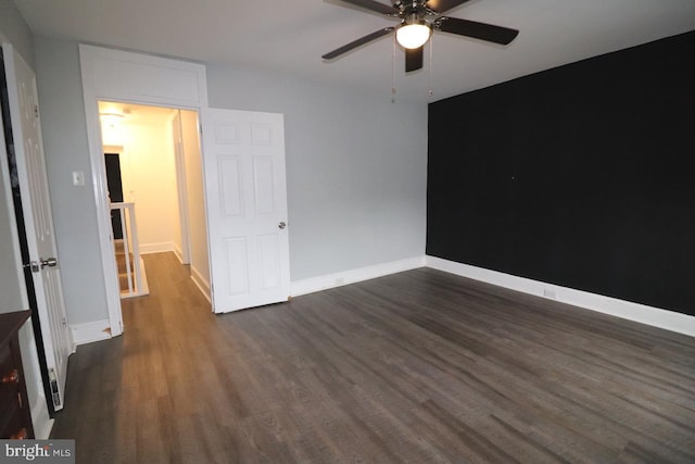 unfurnished bedroom featuring dark hardwood / wood-style flooring and ceiling fan