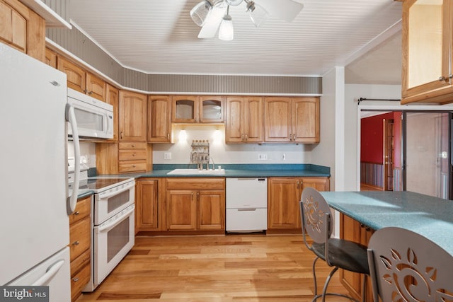 kitchen with sink, white appliances, light hardwood / wood-style flooring, and ceiling fan