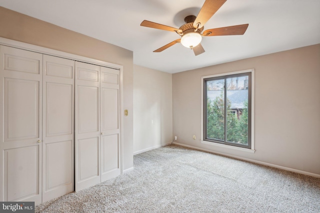 unfurnished bedroom with light carpet, a closet, and ceiling fan