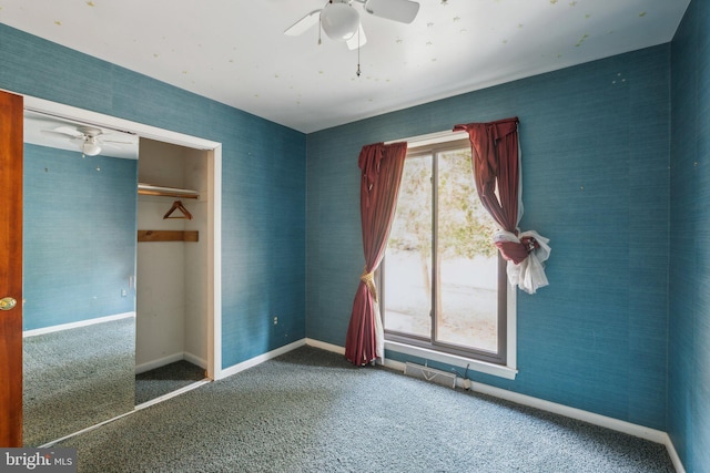 unfurnished bedroom with carpet floors, ceiling fan, and a closet