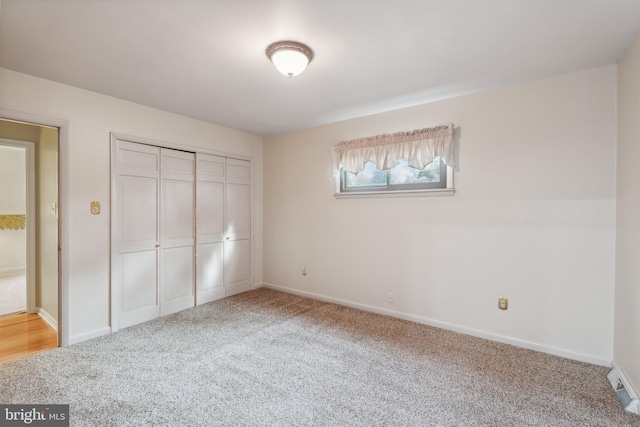 unfurnished bedroom with carpet floors and a closet