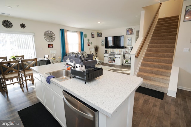 kitchen featuring sink, dishwasher, an island with sink, white cabinets, and dark hardwood / wood-style flooring