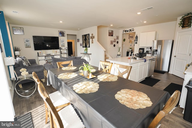 dining area featuring dark wood-type flooring and sink