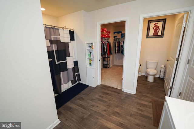 bathroom featuring vanity, hardwood / wood-style floors, a shower with shower curtain, and toilet