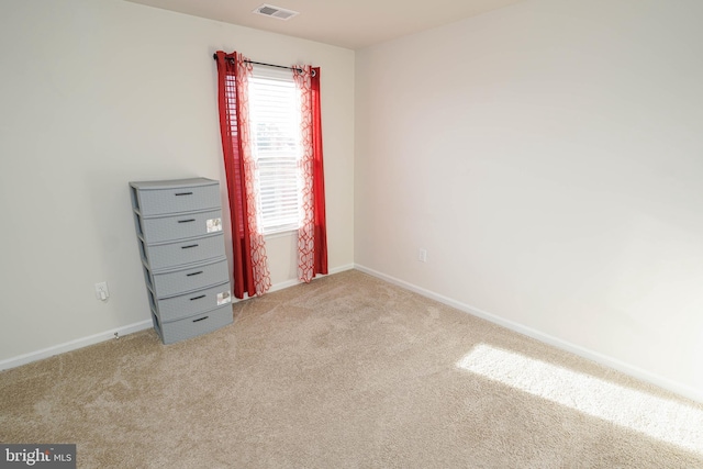 empty room with light colored carpet