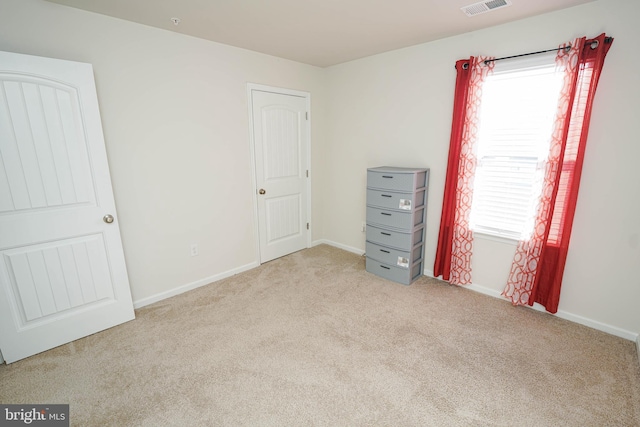 unfurnished bedroom with light colored carpet