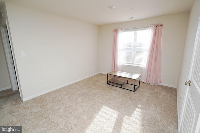 spare room with light colored carpet