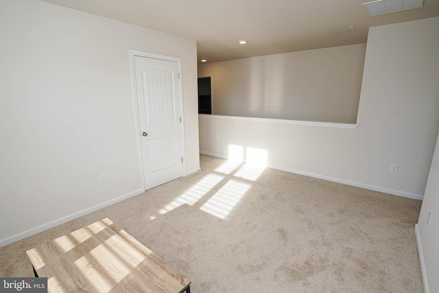 empty room featuring light carpet