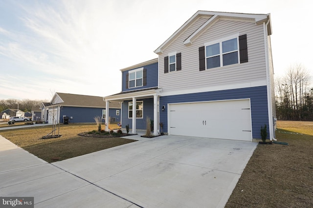 view of front property featuring a garage, a front yard, and covered porch