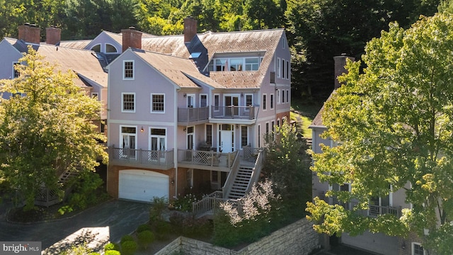 rear view of property with a garage