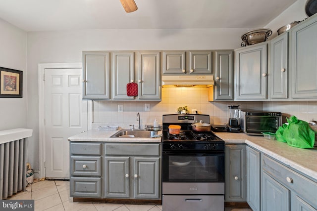 kitchen with sink, decorative backsplash, and gas stove