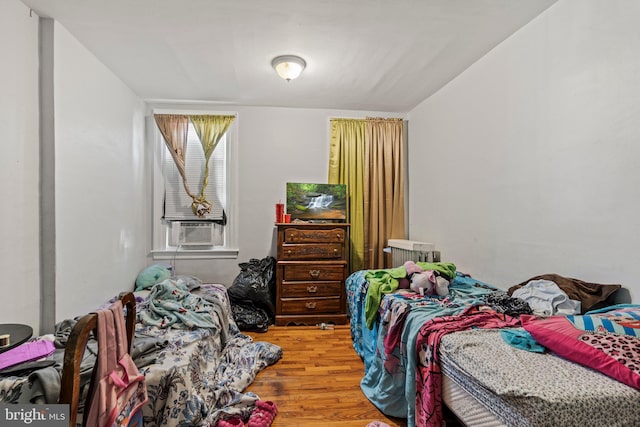 bedroom with hardwood / wood-style flooring and cooling unit