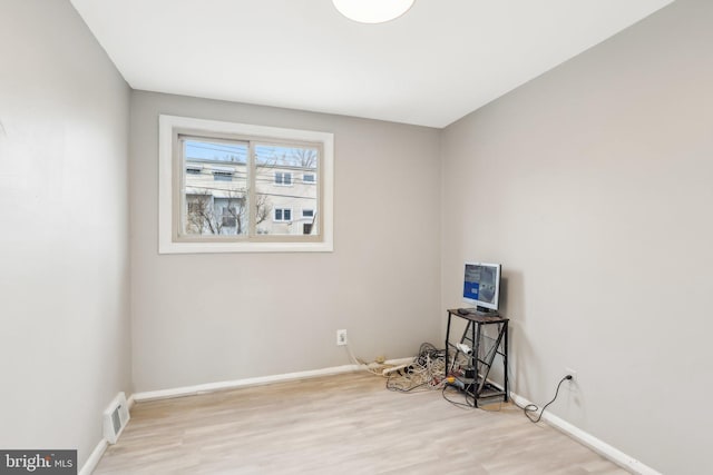 misc room with visible vents, baseboards, and wood finished floors