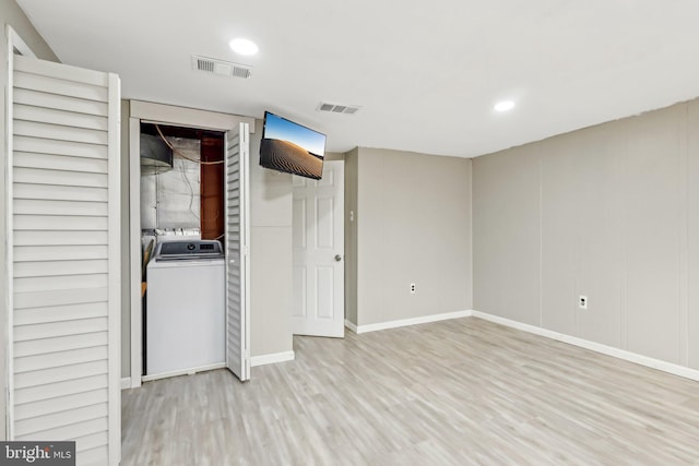 interior space with light wood finished floors, washing machine and dryer, visible vents, and recessed lighting