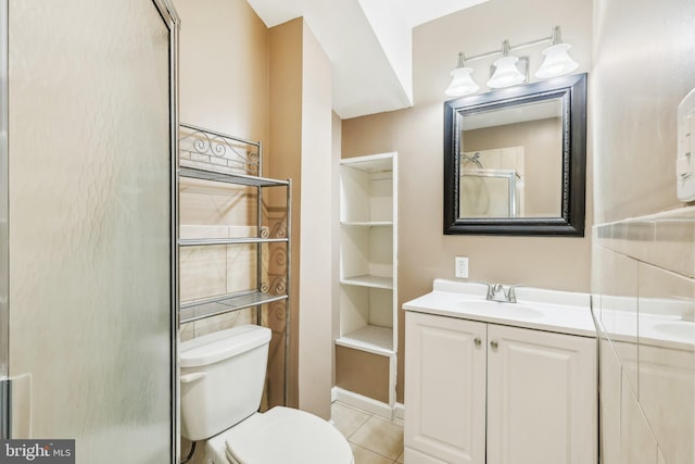 bathroom featuring toilet, tile patterned floors, and vanity