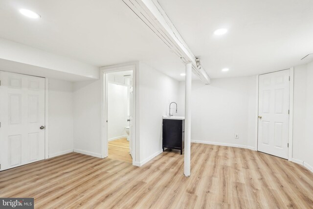 finished basement with recessed lighting, baseboards, and light wood finished floors