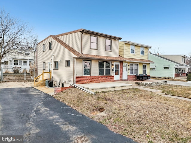 view of front of home with fence and brick siding