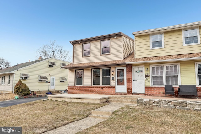 view of front of house featuring covered porch and brick siding