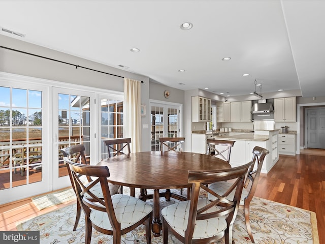 dining space featuring recessed lighting, wood finished floors, visible vents, french doors, and a wealth of natural light