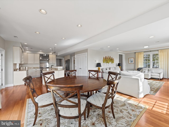 dining area with recessed lighting and light wood-style flooring