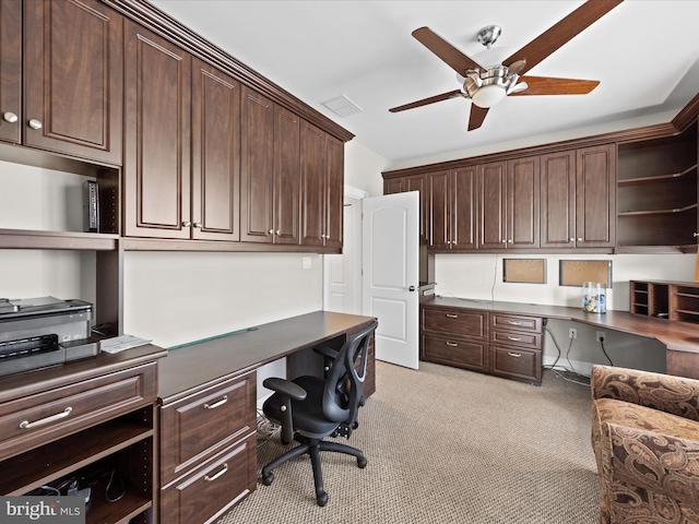 office area with light colored carpet, built in study area, ceiling fan, and visible vents