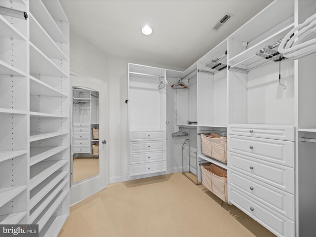 walk in closet with light carpet and visible vents