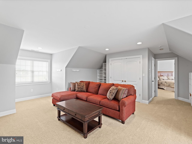 living area with light carpet, vaulted ceiling, recessed lighting, and baseboards