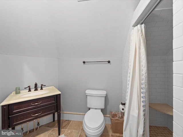 full bathroom with toilet, a stall shower, baseboards, and vaulted ceiling