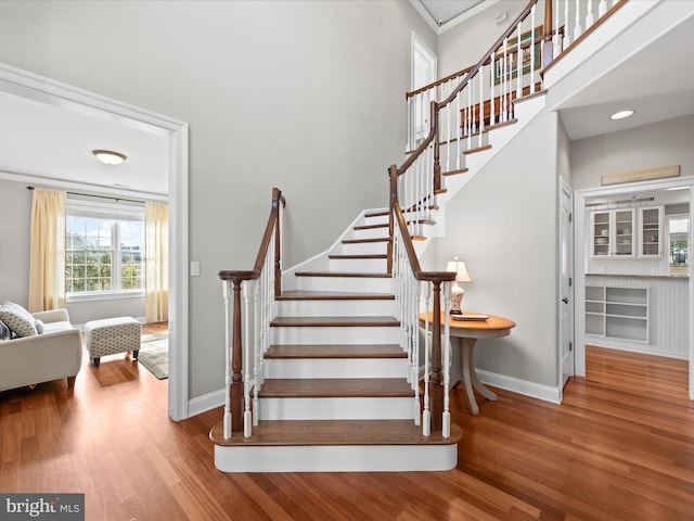 stairs featuring baseboards and wood finished floors