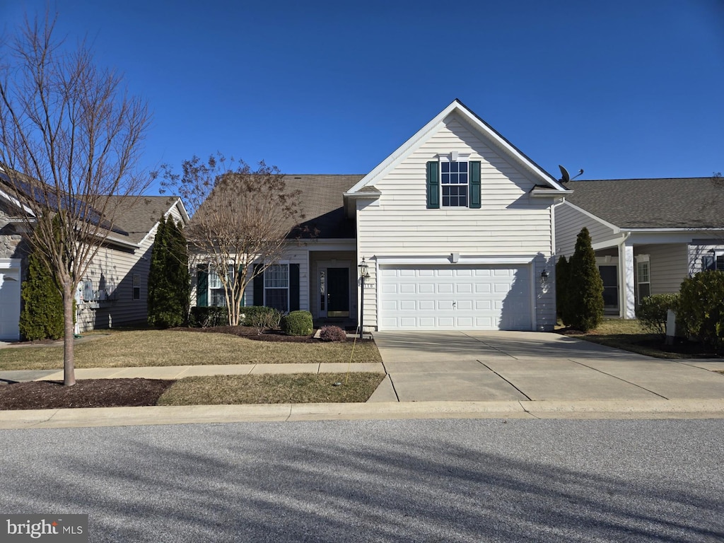 traditional home featuring driveway and an attached garage