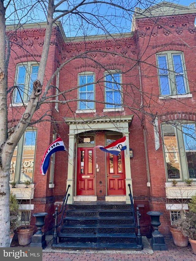 view of front of house featuring entry steps and brick siding