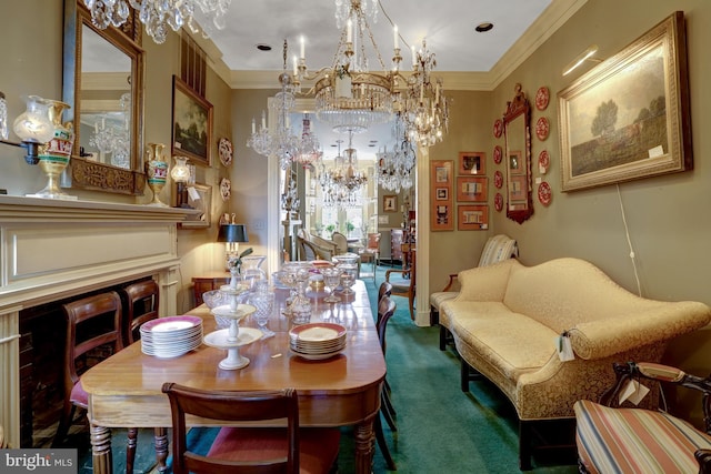 dining room featuring a fireplace, carpet floors, a notable chandelier, and crown molding