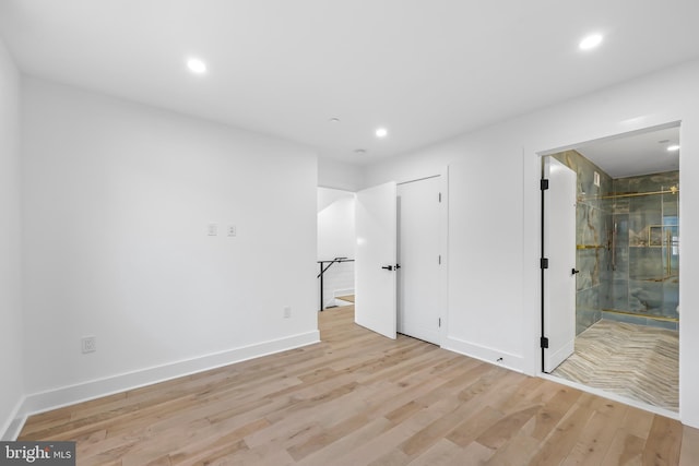 unfurnished bedroom featuring recessed lighting, light wood-style flooring, and baseboards