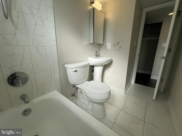 bathroom featuring tiled shower / bath and toilet