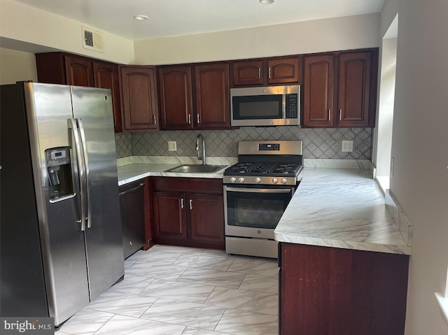 kitchen featuring sink, backsplash, and stainless steel appliances