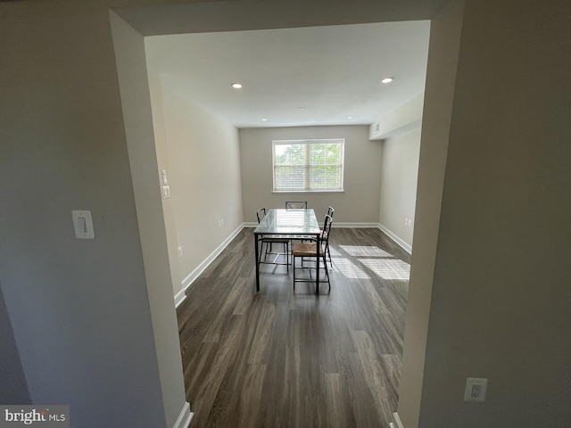 unfurnished dining area featuring dark wood-type flooring