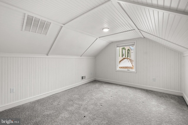 bonus room with carpet flooring and vaulted ceiling