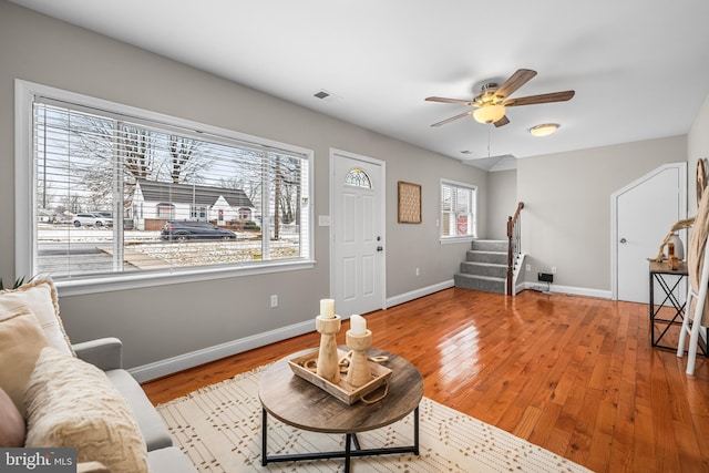 living room with ceiling fan and light wood-type flooring