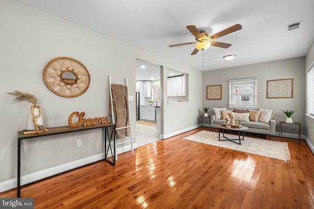 living room featuring ceiling fan and light wood-type flooring