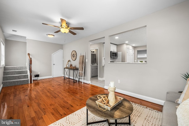 living room featuring ceiling fan and light hardwood / wood-style flooring