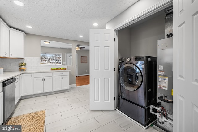 laundry area with washer / dryer, a textured ceiling, and ceiling fan