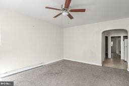 carpeted empty room featuring ceiling fan