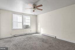 spare room featuring cooling unit and ceiling fan