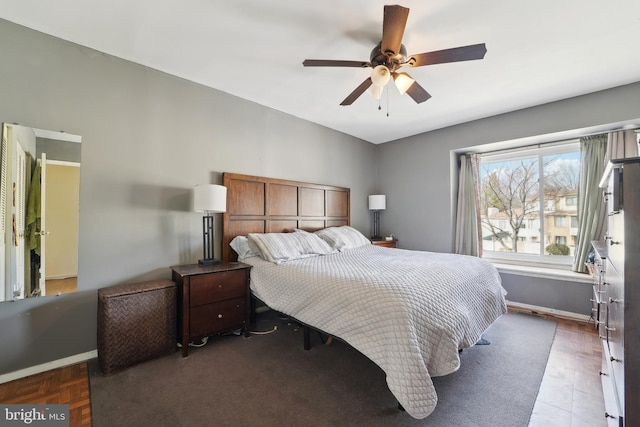 bedroom with a ceiling fan and baseboards