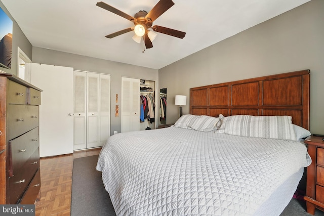 bedroom with a ceiling fan and multiple closets