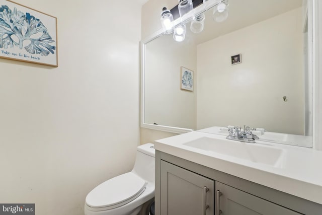 half bathroom featuring toilet and vanity