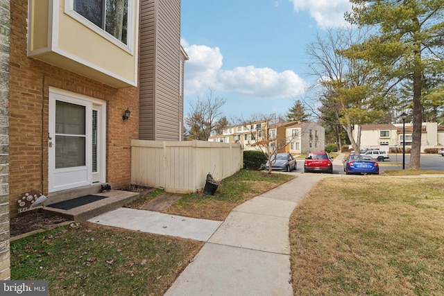 view of yard featuring a residential view and fence